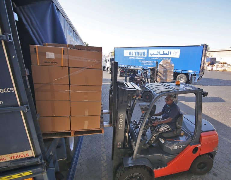 Forklift loading a pallet in a truck for shipment