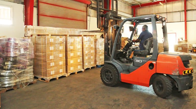 Forkift unloading cargo at Al Talib Shipping Company warehouse Dubai