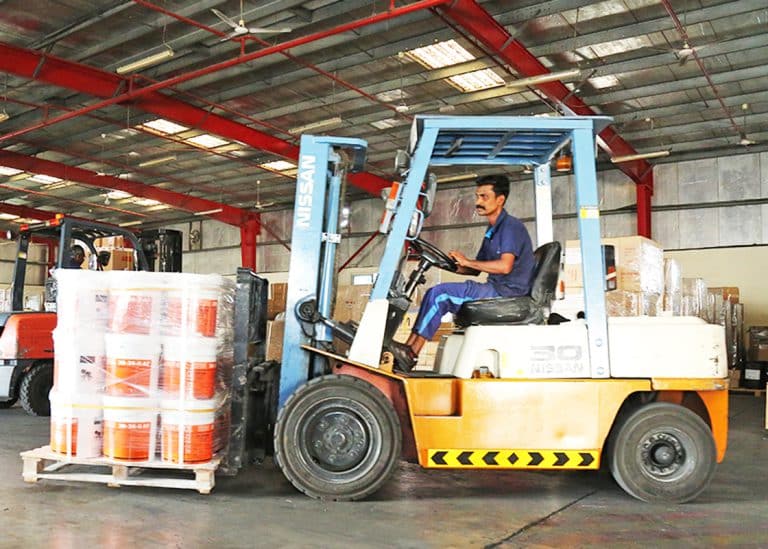 Forklift arranging cargo inside Al Talib shipping Company warehouse
