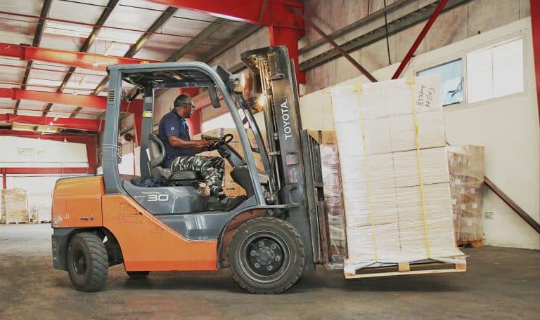 A forklift shifting cargo in Al Talib Shipping warehouse