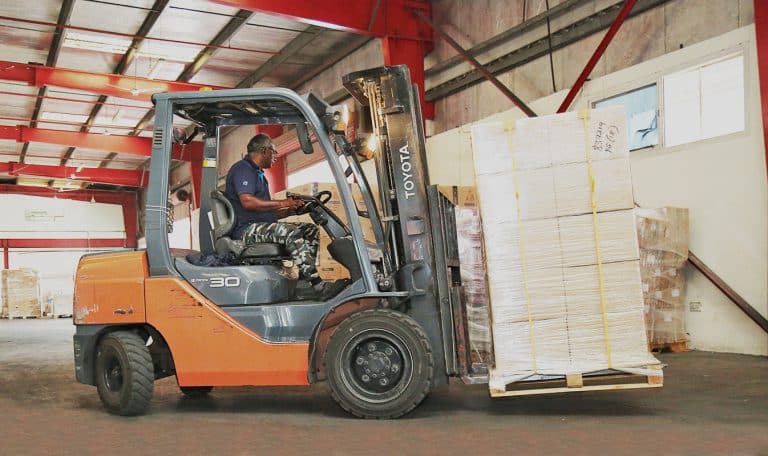 Moving cargo pallet with a forklift inside Al Talib warehouse in Dubai
