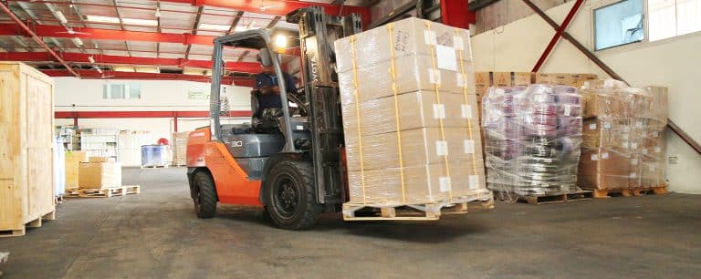 Forklift shifting pallets at Al Talib Shipping Company warehouse