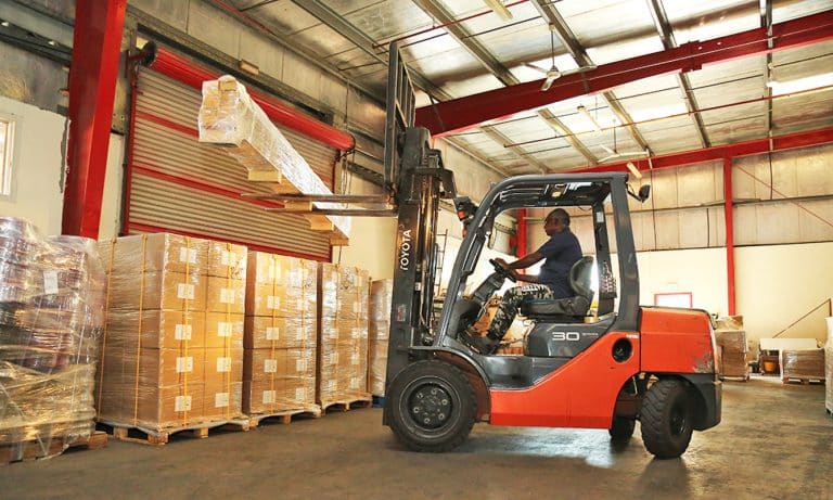 Forkift arranging cargo at Al Talib Shipping Company warehouse Dubai