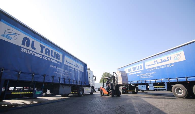 A blue coloured semi trailer truck from Al Talib Shipping Company