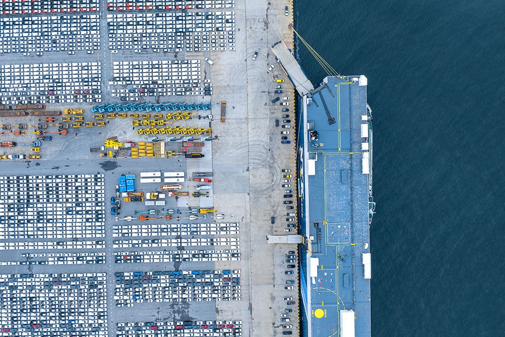 Aerial shot of automobiles waiting for sea shipment