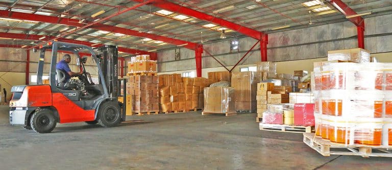 A forklift shifting cargo pallets inside Al Talib warehouse